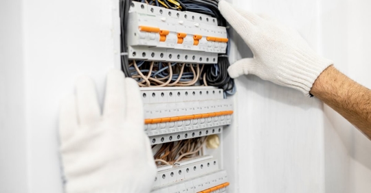 man working on electrical panel