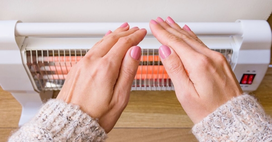 woman using electrical space heater