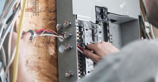 man working on electrical panel