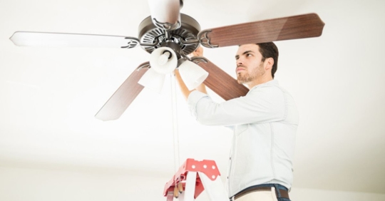 electrician installing ceiling fan