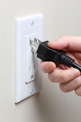 Plugging cord into outlet